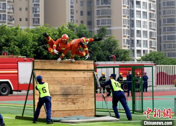 新消防員進(jìn)行消防障礙接力操展示?！⒅铱?攝